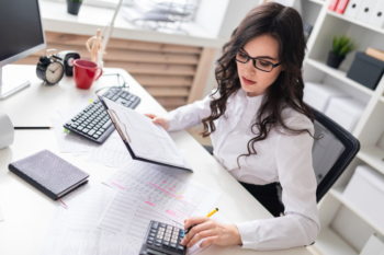 An accountant calculating and creating accounting reports