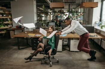 2 office workers having fun enjoying changing culture in their startup