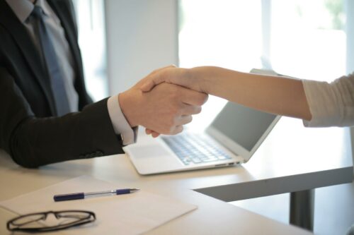 Startup founder and outsourced CFO shaking hands after making a business agreement