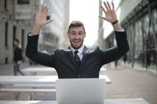 man with hands up