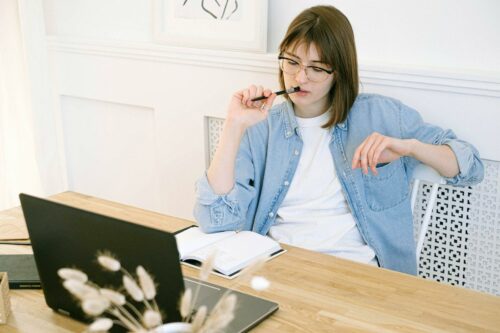 woman in home office thinking about EMI schemes