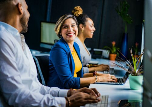 Office workers laughing after discussing business accounting services