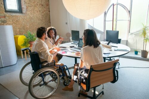 Team meeting around circular table, discussing R&D 2023 claim