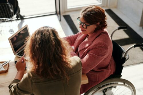 Two workers comparing payroll apps