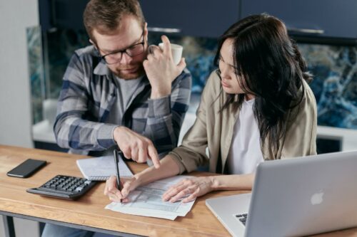 Two business people calculating operating profit