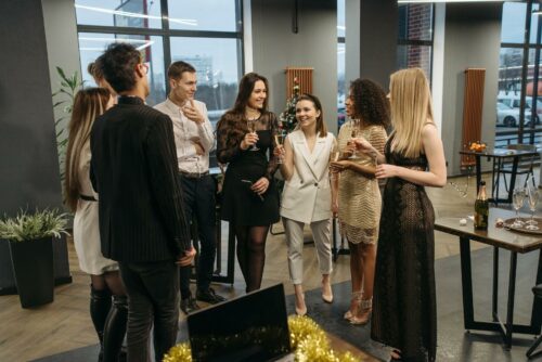 Team in an office celebrating, a qualified expense in their PSA agreement