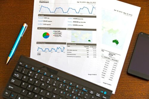 Documents on wooden table, detailing how to scale while saving time and money
