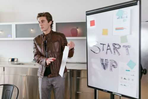 Man stood in front of a white board saying Start up