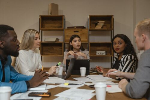 Women round a table discussing how much is corporation tax for a limited company