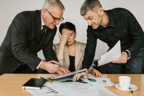 Startup founders arguing about how to manage cashflow in a recession