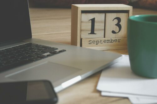 Work desk setup with coffee and a calendar - ready to take on a tax audit in 2023