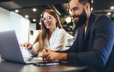 Two people looking at a laptop