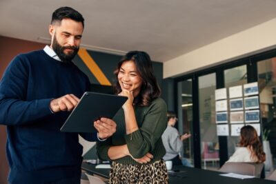 Two people staring at an Ipad
