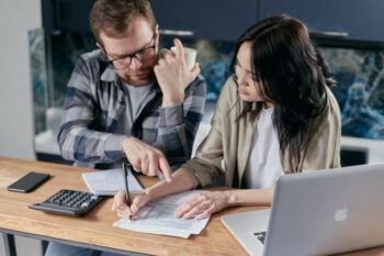 2 people calculating operating profit
